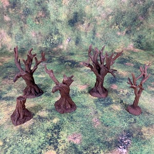 Op de afbeelding: Set van zes miniatuur bomen, geschilderd in bruin, inclusief een stronk, voor gebruik in tabletop games of modeltreinen.