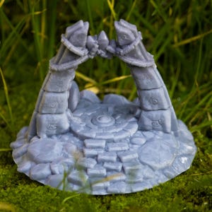 Könnte beinhalten: Eine graue 3D-gedruckte Miniatur eines Steinbogens mit einer runden Steinplattform. Der Bogen besteht aus zwei Steinpfeilern mit in sie geschnitzten Runen. Die Plattform hat ein kreisförmiges Muster in der Mitte.