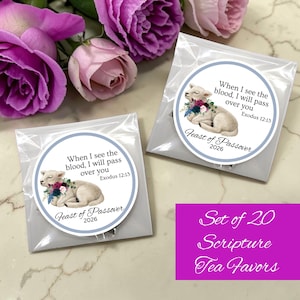 May include: Two tea favor packets with circular labels featuring a lamb illustration and the text "When I see the blood, I will pass over you Exodus 12:13" and "Feast of Passover 2026". A purple rectangle reads "Set of 20 Scripture Tea Favors".
