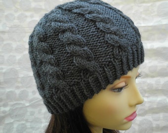 May include: A gray knitted beanie with a cable knit pattern.