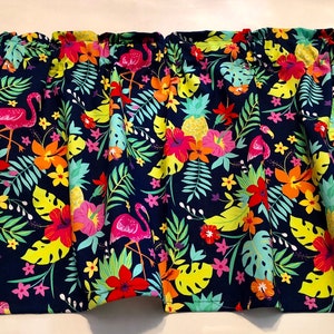 May include: A navy blue fabric valance with a tropical print featuring pink flamingos, yellow pineapples, red hibiscus flowers, and green palm leaves.