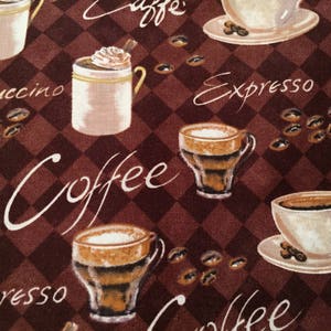 May include: A brown and white fabric with a repeating pattern of coffee cups, coffee beans, and the words "Coffee", "Espresso", "Cappuccino", and "Latte".