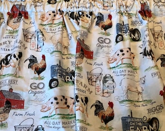 May include: A white fabric curtain featuring a repeating farm-themed print with illustrations of roosters, cows, pigs, sheep, red barns, and blue tractors. The pattern includes text such as Dairy Farm, Go Organic, Farm Fresh, and Life is better on the farm.
