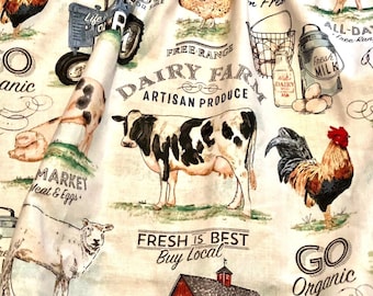 May include: A cream-colored fabric featuring a farm-themed print with a black and white cow, a rooster, a sheep, a tractor, and milk cans. The text includes Dairy Farm, Artisan Produce, Fresh is Best, Buy Local, and Go Organic in black font.