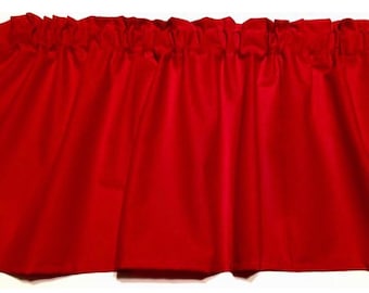 May include: A solid red valance with a gathered top. The fabric is a vibrant shade of red, and the valance is designed to be hung above a window. The material appears to be a smooth, opaque fabric.