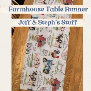 May include: A white farmhouse table runner with a repeating pattern of farm animals, including cows, pigs, chickens, and a red barn. The text "Go Organic", "Dairy Farm", "Fresh is Best", and "Free Range Eggs" is printed on the runner.