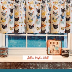 May include: A white valance curtain featuring a repeating pattern of colorful chickens and small flowers. Below the curtain, a metal coffee tin, a square pot holder with the text Coffee Time is Anytime, and a ceramic mug are on a windowsill.