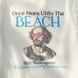 May include: White sweatshirt with a blue and black graphic print of a man wearing sunglasses. The text on the graphic reads "Once More Unto The Beach" and "Billy Shakespeare St. Crispin's Day Long Weekend-1586".