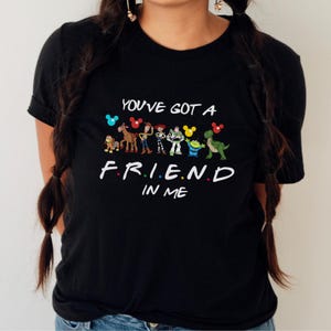 May include: Black t-shirt with a graphic of Toy Story characters and the text "You've got a friend in me."