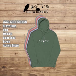 May include: A green hooded sweatshirt with the text "Linger Longer" in white script. The image displays a variety of available colors, including slate blue, pink, maroon, light blue, black, and alpine green. The Bird & Bear Co. logo is at the top.