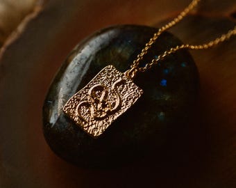 serpent & stone. a minimalist gold snake talisman necklace. symbol of rebirth + wisdom.