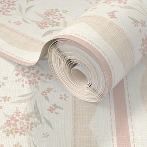 May include: A roll of wallpaper featuring a floral pattern with pink and beige flowers and leaves. The design includes vertical stripes in shades of pink and beige, and a textured, off-white background. The roll is partially unrolled, revealing the pattern.