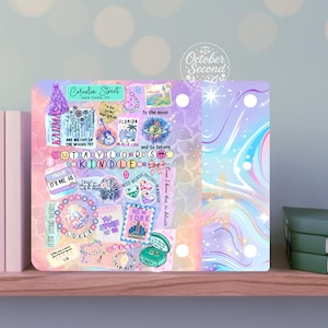 May include: A decorative Kindle cover featuring a collage of colorful graphics and text. The design includes the words "Cornelia Street," "Karma," "Taylor's Kindle," and other phrases, with a pastel color scheme and a whimsical aesthetic.