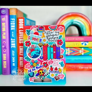 May include: A colorful book cover with stickers, including text that says "Summer never ends" and "Hottin' my bumper reading goals." The cover is surrounded by books and a rainbow decoration. The words "All the Books" are also visible.