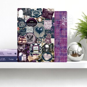 May include: A decorative phone case with a collage of dark academia and gothic elements. Features text like "Dark Romance Addict" and "Enemies to Lovers". Includes a skull, lips, and a heart.