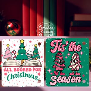 May include: Two Christmas-themed square ornaments. One features a Christmas tree design with the text "ALL BOOKED FOR Christmas". The other ornament has two cartoon Christmas trees with the text "Tis' the Season". Both have a hole for hanging.