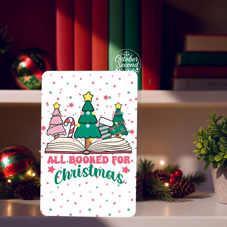 May include: A white rectangular Christmas card with the text "ALL BOOKED FOR Christmas". The card features illustrations of Christmas trees, candy canes, and an open book, with a background of red and green polka dots.