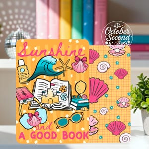 May include: A rectangular card featuring an orange background with the text Sunshine and a GOOD BOOK. Illustrations include a blue wave, a starfish, a pink seashell, a sandcastle, a lemon, sunglasses, and a bag. The right side shows a grid pattern with pink seashells.