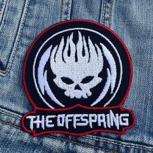 May include: A circular patch with a white skull and flame design on a black background, edged with red. The text "THE OFFSPRING" is in white on a black and red banner below the skull.