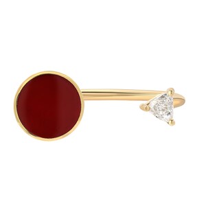 May include: A gold ring featuring a red circular stone and a triangular diamond. The ring is open and can be adjusted to fit different finger sizes.