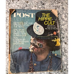 May include: Vintage magazine cover featuring a man with painted face and a hat with the word "LSD". The magazine is titled "POST" with the headline "THE HIPPIE CULT". Additional text includes "Detroit's Top Cop Speaks Out on the Riots".