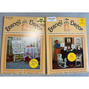 May include: Two packages of reusable decorative stencils for interior walls, fabrics, furniture, and floors. The packages are labeled "Stencil Decor" and feature images of a woman using the stencils. One package includes pre-cut stencils, while the other includes uncut stencils. Both packages feature a pineapple design.