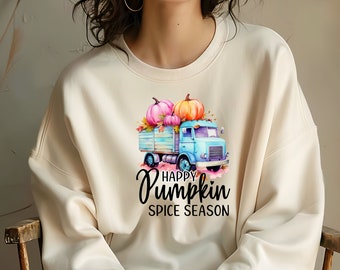 May include: Cream-colored sweatshirt featuring a watercolor illustration of a light blue truck carrying pumpkins. The pumpkins are pink and orange, with fall leaves. The text reads "Happy Pumpkin Spice Season" in black script.