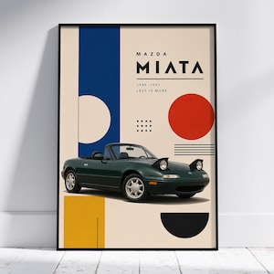 May include: A framed art print featuring a green Mazda Miata convertible. The artwork has a minimalist design with geometric shapes in blue, yellow, red, and black. Text reads "MAZDA MIATA 1989-1997 LESS IS MORE."