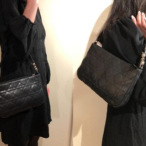 May include: Two black quilted shoulder bags with silver hardware. The bags have a flap closure and a chain strap.
