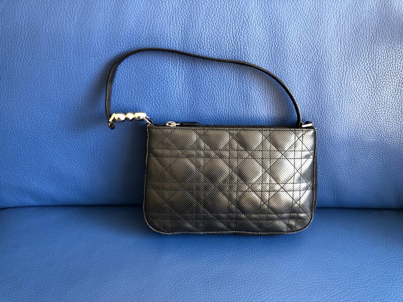 May include: A black quilted leather handbag with a silver chain strap.