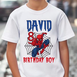 May include: White t-shirt with a blue and red Spiderman graphic, a web, and the text "DAVID BIRTHDAY BOY" with the number 8.