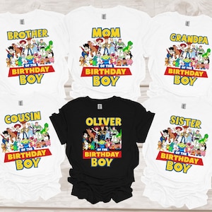 May include: White and black t-shirts with a Toy Story graphic. The white shirts have text that says "Brother", "Mom", "Grandpa", "Cousin", and "Sister" above "Of The Birthday Boy". The black shirt says "Oliver" above "Of The Birthday Boy".