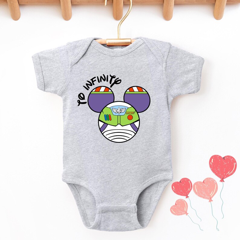 May include: Gray baby onesie with a cartoon image of Buzz Lightyear from Toy Story. The image is in the shape of Mickey Mouse ears and says "To Infinity".