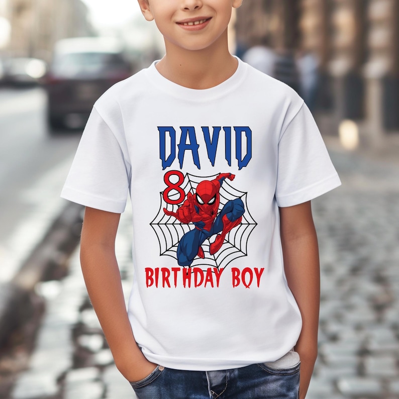 May include: White t-shirt with a blue and red Spiderman graphic, a web, and the text "DAVID BIRTHDAY BOY" with the number 8.