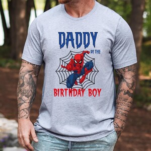 May include: Gray t-shirt with a red and blue Spiderman graphic and the text "Daddy of the Birthday Boy".