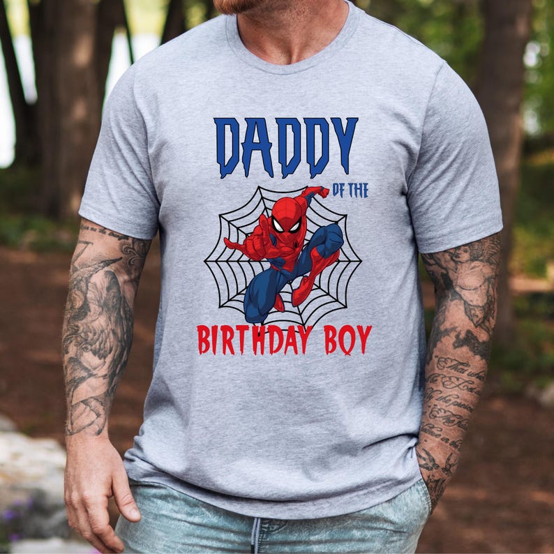 May include: Gray t-shirt with a red and blue Spiderman graphic and the text "Daddy of the Birthday Boy".