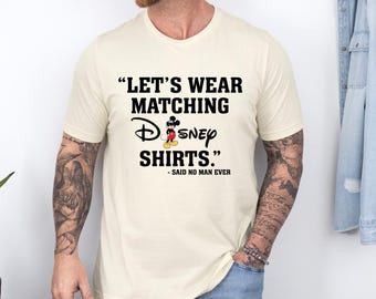May include: A white t-shirt with a black graphic that says "Let's wear matching Disney shirts." with a cartoon image of Mickey Mouse wearing sunglasses. The text below the graphic says "Said no man ever."