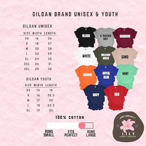 May include: Size chart for Gildan brand unisex and youth t-shirts. The chart shows the width and length measurements in inches for each size. The chart also includes a color chart with 12 different colors. The text "100% Cotton" is printed below the chart. The text "Runs Small", "Fits Perfect", and "Runs Large" are printed below the chart. The text "Just Dream It" and "Lily Comes Through" are printed below the chart.