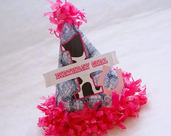 May include: A pink and white birthday party hat with a disco ball pattern and the words "Birthday Girl" on a white banner. The hat has a pink and white fringe around the bottom.