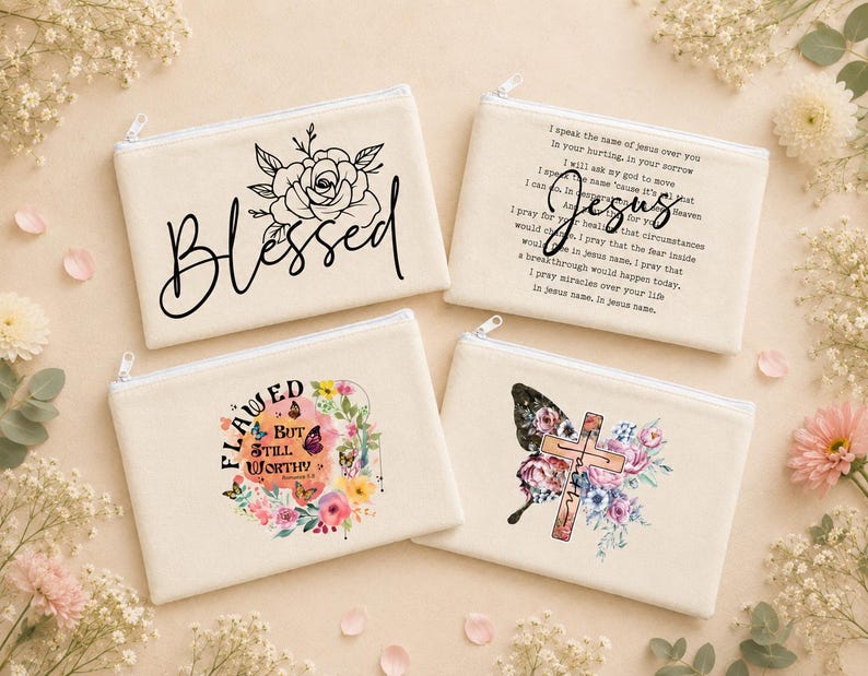 May include: Four rectangular off-white canvas zipper pouches. One features a black rose and the word Blessed. One has text about Jesus. One displays a floral wreath with butterflies and the text Flawed But Still Worthy. One shows a cross and flowers.