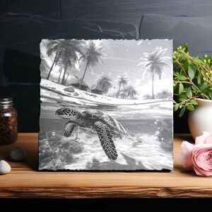 May include: A black and white photo of a sea turtle swimming in the ocean. The turtle is in the foreground, and the background shows a tropical beach with palm trees.