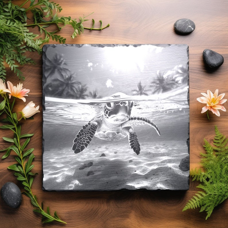 May include: A black and white photo of a sea turtle swimming underwater. The turtle is facing the camera and has its head and flippers visible. The background is a blurry image of palm trees and the ocean.