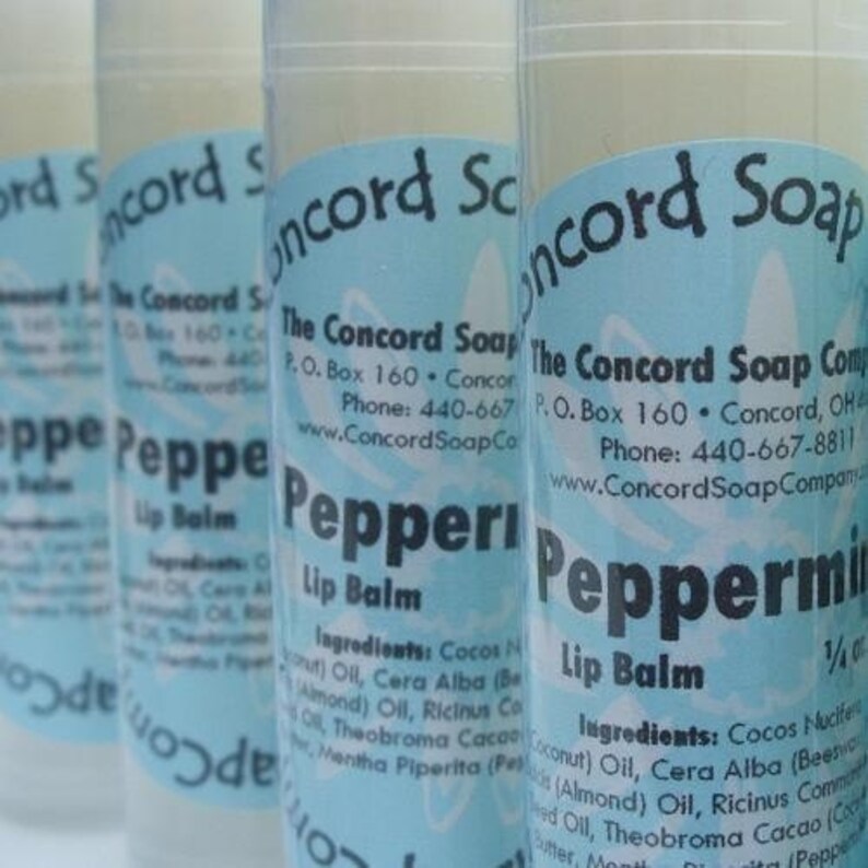 May include: Four tubes of peppermint lip balm with blue and white labels. The labels read "The Concord Soap Company", "Peppermint Lip Balm", and list the ingredients.