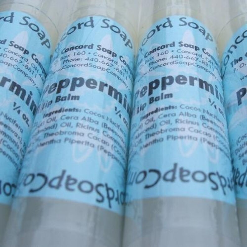 May include: Three blue and white labeled tubes of peppermint lip balm. Each tube is labeled "Concord Soap Company" and lists the ingredients: Cocos Nucifera (Coconut) Oil, Cera Alba (Beeswax), Ricinus Communis (Castor) Oil, Theobroma Cacao (Cocoa) Butter, Mentha Piperita (Peppermint).