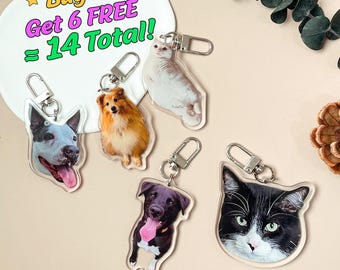 May include: A collection of clear acrylic keychains featuring images of dogs and cats. The keychains have silver-colored clasps. The image also includes text that reads "Buy 8, Get 6 FREE = 14 Total!"