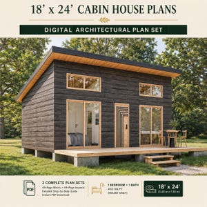 May include: Digital architectural plan set for an 18' x 24' cabin house. The cabin features dark horizontal wood siding, a shed roof, a wooden deck, sliding glass doors, and a patterned door. Includes 49-page metric and imperial plan sets.