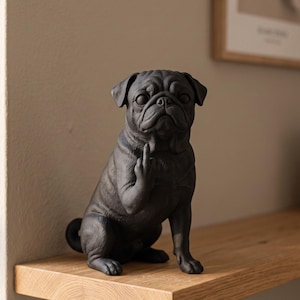 Könnte beinhalten: Eine mattschwarze Mops-Figur in sitzender Position. Der Mops hat ein faltiges Gesicht und ist mit erhobener rechter Vorderpfote dargestellt, wobei der Mittelfinger in einer Geste ausgestreckt ist. Die Skulptur zeigt eine detaillierte Fellstruktur.