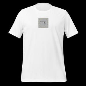 May include: White t-shirt with a gray square featuring the text "TTC" in black.