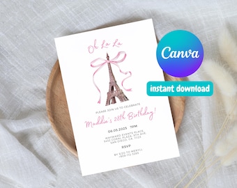 May include: A white invitation card with pink text and a pink ribbon tied around a watercolor illustration of the Eiffel Tower. The text reads "Oh La La" and "Please join us to celebrate Maddie's 28th Birthday!" with the date, time, location, and RSVP information.