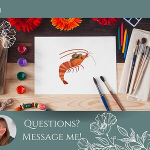 May include: A watercolor painting of a shrimp wearing a cowboy hat. The painting is on a white sheet of paper, surrounded by paintbrushes, paint tubes, and crayons. The background is a wooden table with flowers.